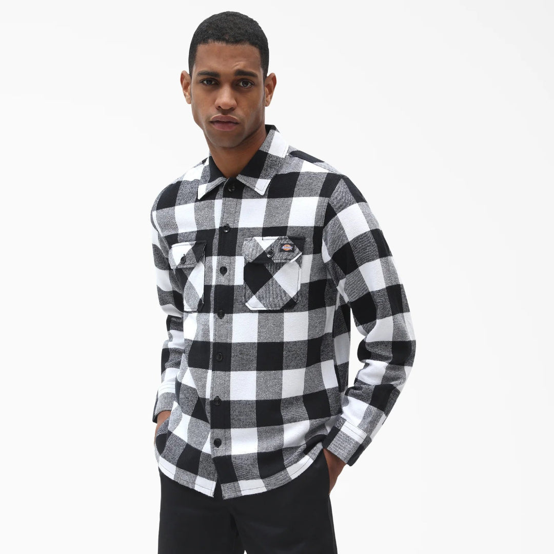 Man wearing a black and white checkered shirt on a white background